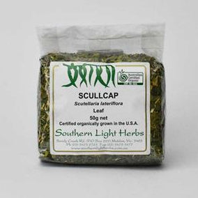 A 10g net package of Southern Light Herbs Scullcap (Scolopendra labellerum) leaf, showing the green dried herbs through a clear plastic bag with a white and green label, set against a plain light gray background.
