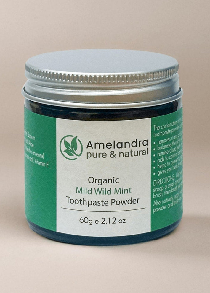 Amelandra organic toothpaste powder jar on a beige background