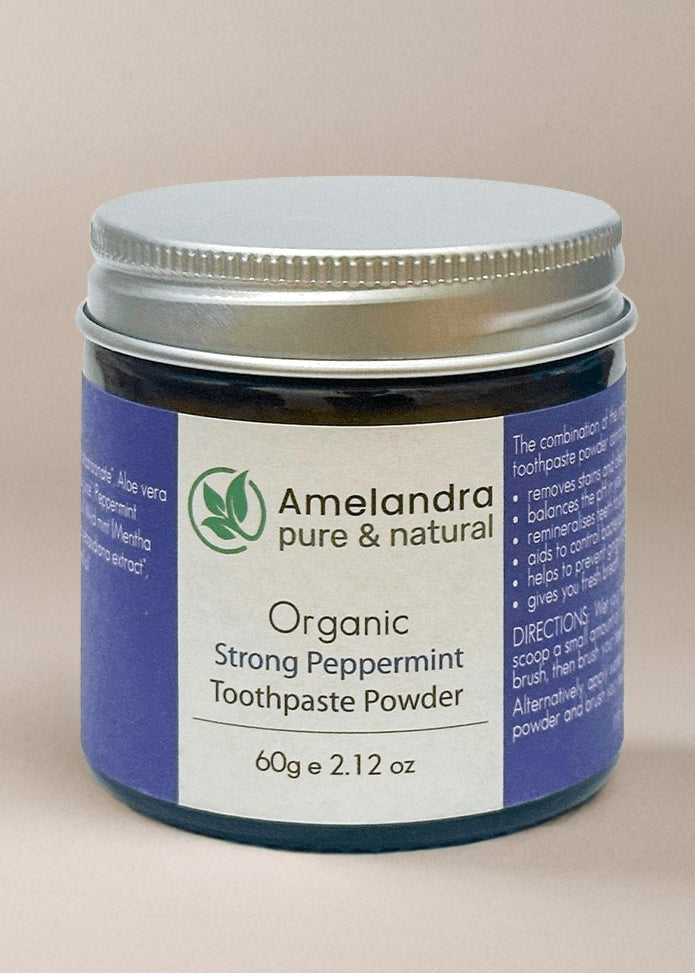 Amelandra organic toothpaste powder jar on a beige background